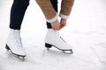 Woman lacing figure skate on ice rink, closeup Royalty Free Stock Photo