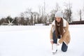 Woman lacing figure skate on ice rink. Space for text Royalty Free Stock Photo