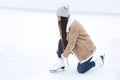 Woman lacing figure skate on ice rink. Space for text Royalty Free Stock Photo