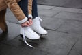 Woman lacing figure skate outdoors, closeup. Space for text Royalty Free Stock Photo