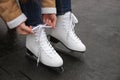 Woman lacing figure skate outdoors, closeup view Royalty Free Stock Photo