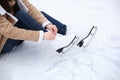 Woman lacing figure skate while sitting on ice, closeup Royalty Free Stock Photo