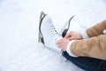 Woman lacing figure skate while sitting on ice rink, closeup Royalty Free Stock Photo