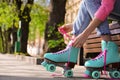 Woman lacing roller skates while sitting on bench outdoors, closeup Royalty Free Stock Photo