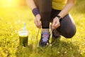 Woman lacing running shoes before workout.