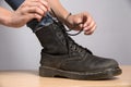 Woman lacing up a black boot Royalty Free Stock Photo