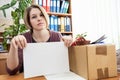 Woman, laid off at work, holding white paper Royalty Free Stock Photo