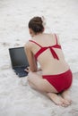 Woman with laptop on the beach Royalty Free Stock Photo