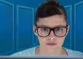 Woman on laptop with blue servers background Royalty Free Stock Photo