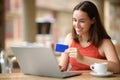 Woman with laptop buying online in a bar Royalty Free Stock Photo