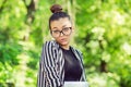 Woman with a laptop, in a city park with funny face Royalty Free Stock Photo