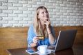 Woman with laptop and credit card in cafe . Online payment, digital banking. Young girl shopping Royalty Free Stock Photo