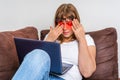 Woman with laptop having tired and sore eyes