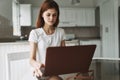 Woman with laptop in the kitchen glasses model freelancer desk office