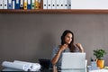 Woman, laptop and paperwork at desk with telephone for phone call, conversation and talking to client. Receptionist Royalty Free Stock Photo