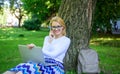 Woman with laptop in park order item on phone. Girl takes advantage of online shopping. Save your time with shopping Royalty Free Stock Photo