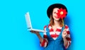 Woman with laptop and pinwheel Royalty Free Stock Photo