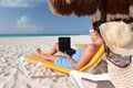 Woman with laptop relaxing on the deckchair