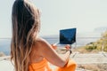 Woman laptop sea. Working remotely on seashore. Happy successful woman female freelancer working on laptop by the sea at Royalty Free Stock Photo