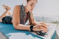 Woman laptop sea. Working remotely on seashore. Happy successful woman female freelancer working on laptop by the sea at Royalty Free Stock Photo