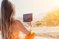 Woman laptop sea. Working remotely on seashore. Happy successful woman female freelancer working on laptop by the sea at Royalty Free Stock Photo