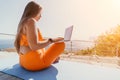 Woman laptop sea. Working remotely on seashore. Happy successful woman female freelancer working on laptop by the sea at Royalty Free Stock Photo