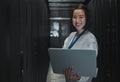 Woman with laptop, server room and information technology, smile in portrait with engineer and datacenter Software Royalty Free Stock Photo