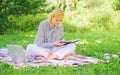 Woman with laptop sit on rug grass meadow. Girl with notepad write note. Freelance career concept. Guide starting