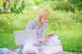 Woman with laptop sit on rug grass meadow. Online or freelance career ideas concept. Guide starting freelance career