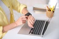 Woman with laptop using smartwatch at white table, closeup Royalty Free Stock Photo