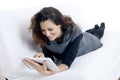 Woman with laptop on white sheet in her bed Royalty Free Stock Photo