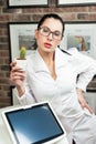 a woman in a laser hair removal studio with a cactus in her hand as a symbol of unwanted hair growth Royalty Free Stock Photo