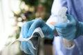 Woman in latex gloves cleaning railing with wet wipe and detergent, closeup