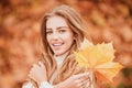 Woman laughing in autumn park. Beautiful Carefree curly girl in trendy fashion outfit smiling enjoy rest. Funny blonde Royalty Free Stock Photo