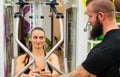 Woman laughing at a bearded man at a gym. Royalty Free Stock Photo