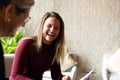 Woman laughing while discussing with coworker in meeting Royalty Free Stock Photo