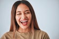 Woman is laughing, happiness and face with freedom on studio background, comedy and care free. Headshot, young