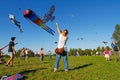 Woman launches a kite into the sky at the kite festival in the Park Tsaritsyno in Moscow