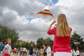 Woman launches a kite into the sky at the kite festival in Volgograd