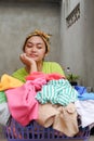 Asian Ethnic young adult woman and basket of Laundry