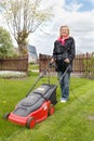 Woman with lawn mower Royalty Free Stock Photo