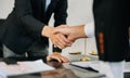 Woman lawyer hand and women client shaking hand collaborate on working agreements with contract documents at the modern office Royalty Free Stock Photo