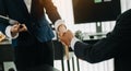 Woman lawyer hand and women client shaking hand collaborate on working agreements with contract documents at the modern office Royalty Free Stock Photo