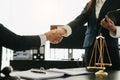 Woman lawyer hand and women client shaking hand collaborate on working agreements with contract documents at the modern office Royalty Free Stock Photo