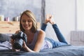 Woman laying on a bed and looking into camera