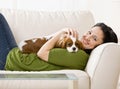 Woman laying on couch with puppy