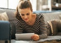 Woman laying on couch and using tablet pc Royalty Free Stock Photo