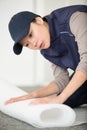 woman laying down floor insulation