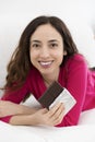 Woman laying and eating chocolate Royalty Free Stock Photo