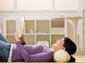 Woman laying on floor enjoying reading a book
